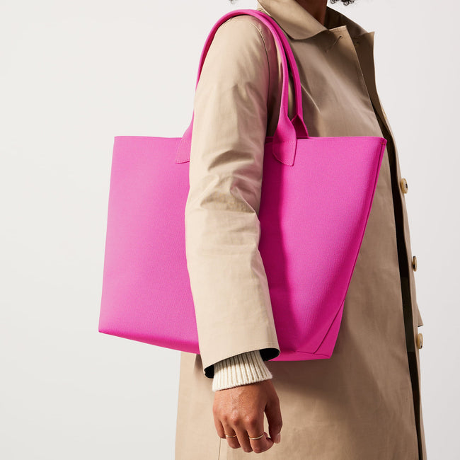 Model holding The Lightweight Tote in Dragon Fruit.