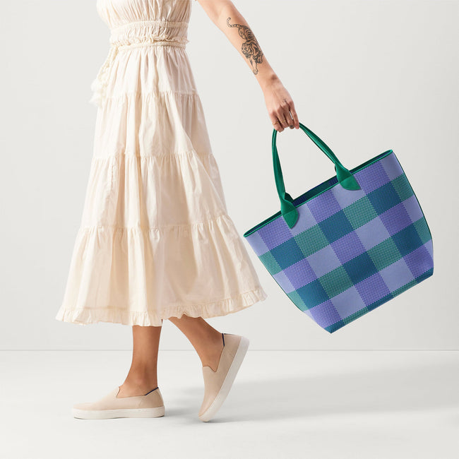 An alternate view of model holding The Lightweight Tote in Blueberry Gingham.