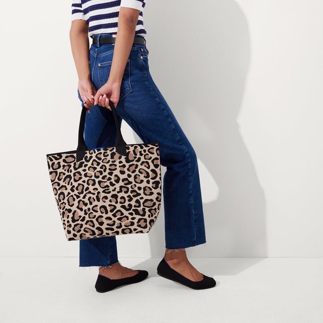 An alternate view of model holding The Lightweight Tote in Desert Cat.