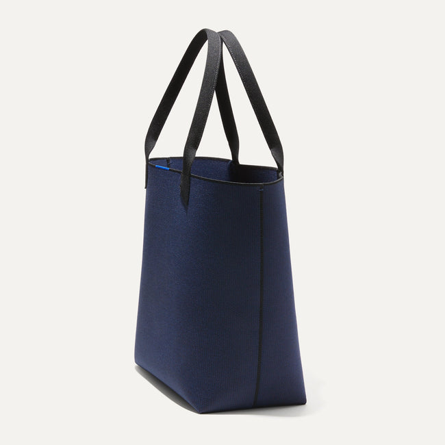 The Lightweight Tote in Sapphire and Onyx shown in diagonal view. 