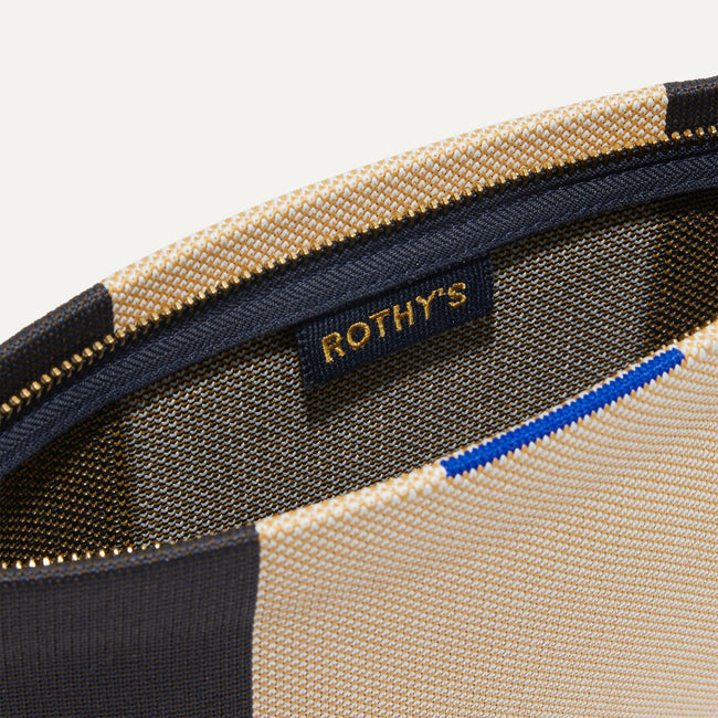 The Wristlet in Ink and Ivory interior view with Rothy's halo detail.