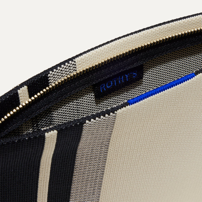 The Wristlet in ivory Rugby Stripe interior view with Rothy's halo detail.