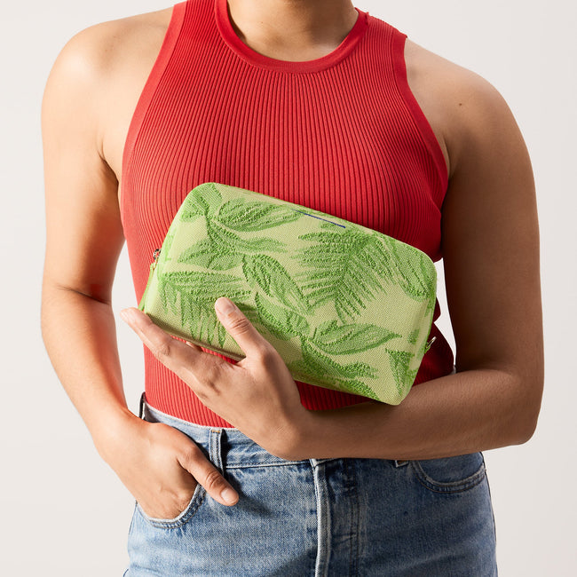 hover | The Universal Pouch in Palm Leaf held by model.