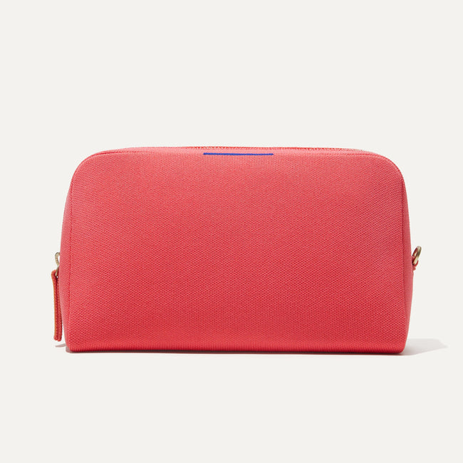 The Universal Pouch in Ruby Grapefruit shown from the front. 