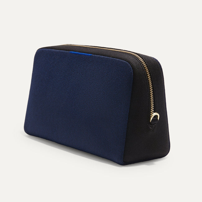 The Universal Pouch in Sapphire and Onyx shown at a diagonal view from the right.