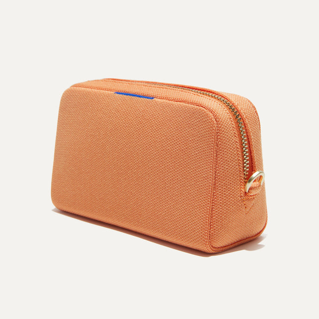 The Mini Universal Pouch in Clementine shown at a diagonal view from the right.