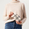 hover | The Mini Universal Pouch in Cream and Black Plaid held by model.