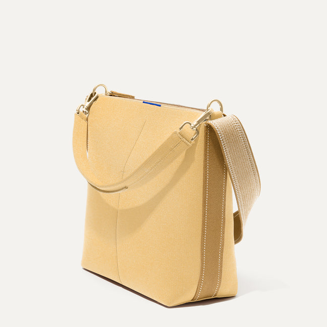 The Mini Zip Bucket in Butter Yellow shown at a diagonal view from the left.