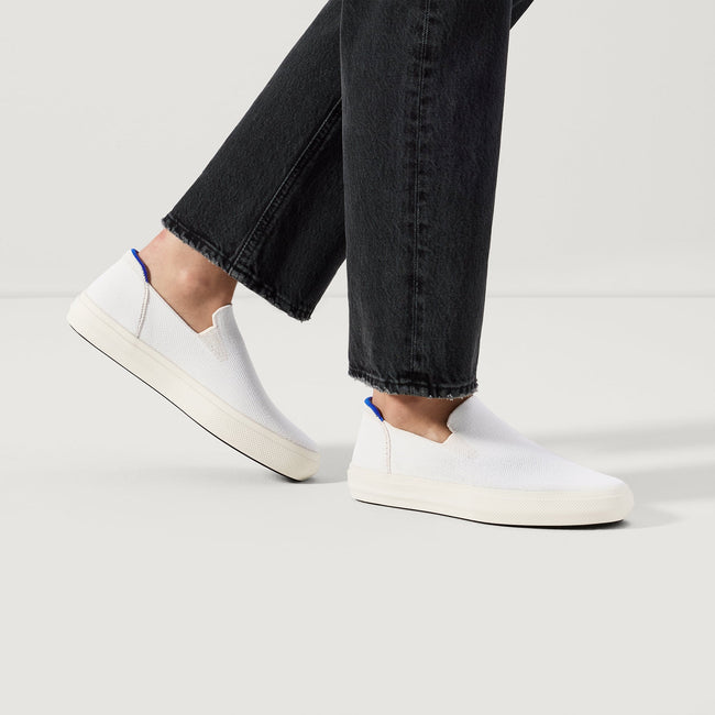 hover | Model wearing The City Slip On Sneaker in White.