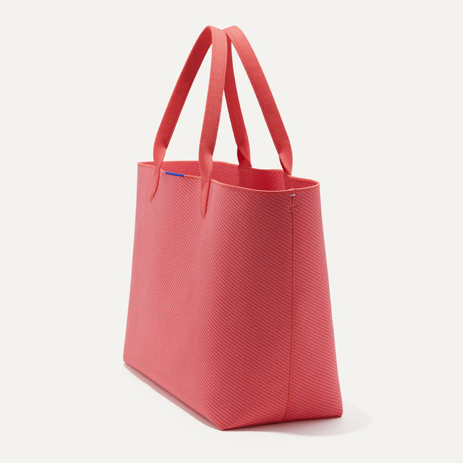 The Lightweight Mega Tote in Ruby Grapefruit Twill, shown from the side.