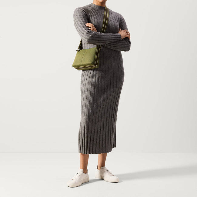 The Casual Crossbody in Evergreen, worn as a crossbody by a model, shown from the front. 