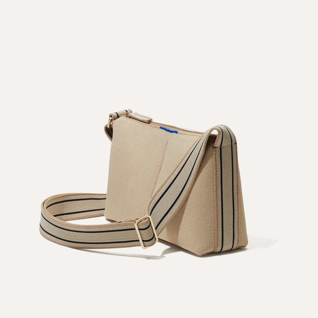 The Casual Crossbody in Parchment, shown from the side at an angle.